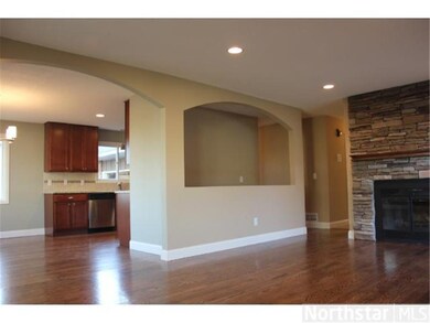 Three separate arched openings give the main level
