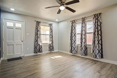 Foyer with ceiling fan, wood-type flooring, and a 