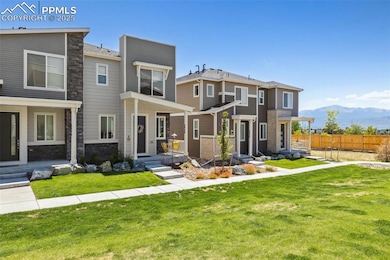 Front view of property with a mountain view and grass community area