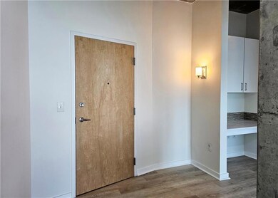 Hall with wood finished floors and baseboards