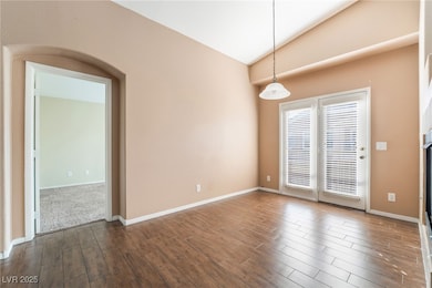 Empty room with dark wood-type flooring, baseboard