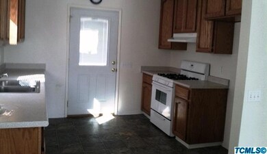 Kitchen has oak cabinets, open floor, en