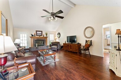 Living room featuring beamed vaulted ceiling and f
