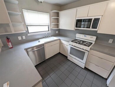 Kitchen featuring stainless steel appliances, ope