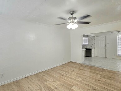 Unfurnished living room featuring ceiling fan, cro