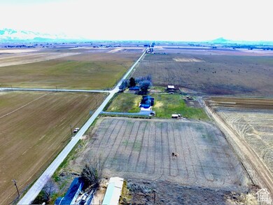 Aerial view of property and surrounding area featuring rural landscape and extensive farmland