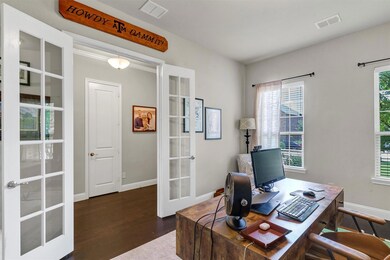 Office space featuring french doors and dark hardw