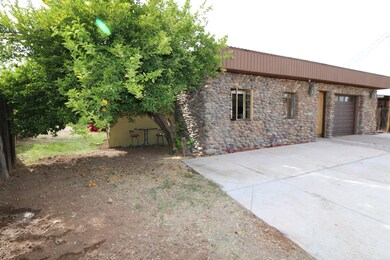 Side of home with shade tree