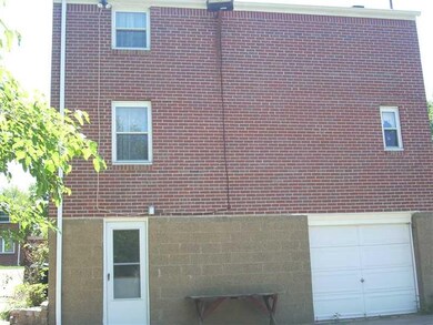 Exterior Back. REAR ENTRANCE & INTEGRAL GARAGE