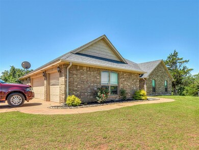 Ranch-style house with a garage and a front lawn