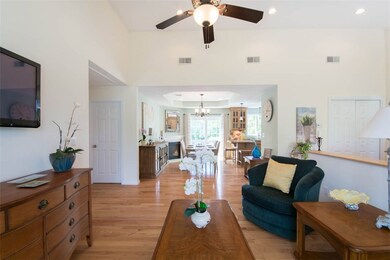 Gleaming hardwood floors looking toward dining are
