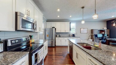 High end cabinetry, granite countertops, tasteful backsplash
