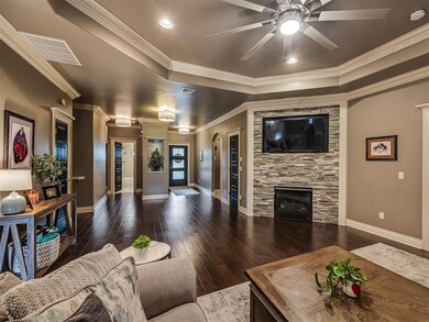 Living room featuring crown molding, ceiling fan, 