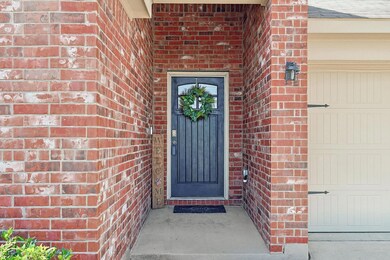 Doorway to property featuring a garage