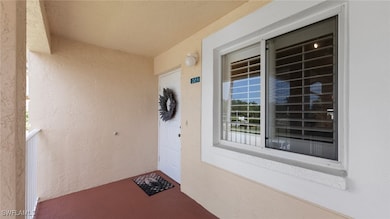 Doorway to property featuring stucco siding