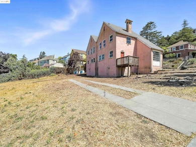 View of side of home with stucco siding and a chimney