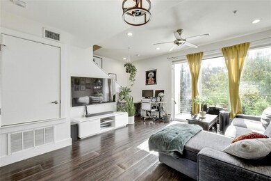 Living area with visible vents, recessed lighting