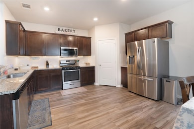 Kitchen featuring stainless steel appliances, a s