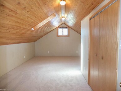 Bedroom 1 has a wood paneled ceiling and a skyligh