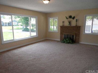 Living room with fireplace and new windows.