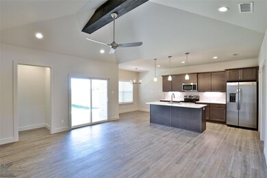 Kitchen featuring stainless steel appliances, beam