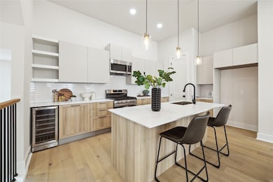 Modern kitchen featuring sleek cabinetry, a spacio