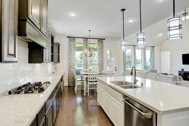 Kitchen is open to family room keeping the heart of the home connected. Cook while you watch tv with the whole family!