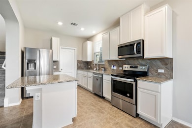 Kitchen with arched walkways, stainless steel app