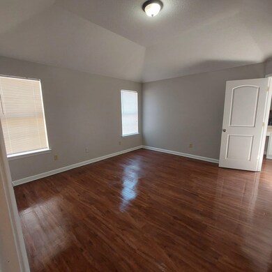 Unfurnished room featuring vaulted ceiling and dar