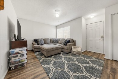 Living room with baseboards, wood finished floors,