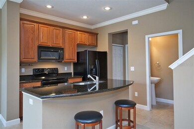 Galley kitchen w/ raised panel wood cabinets and g