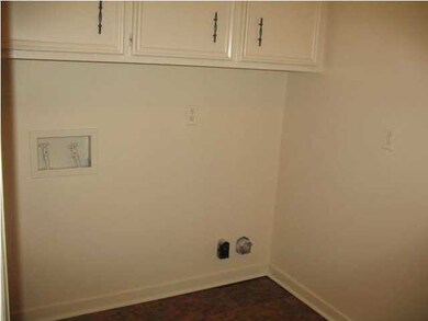 separate laundry room with storage