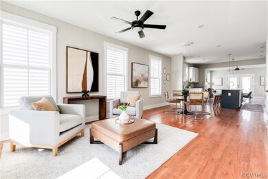 Living room featuring sink, light wood-type floori