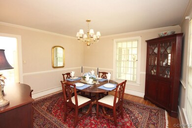 Formal dining room with hardwood floors.