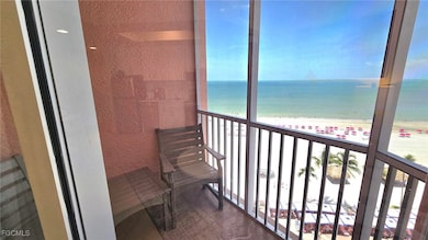 Balcony featuring view of water and beach