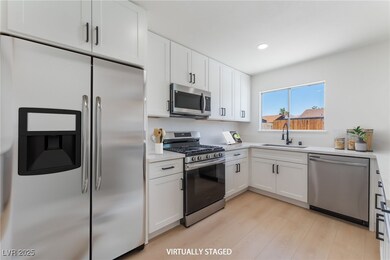 Kitchen with stainless steel appliances, light woo