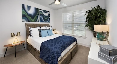 Bedroom featuring multiple windows, carpet floors,