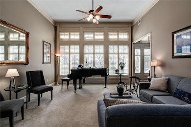 Large carpeted living room with crown molding