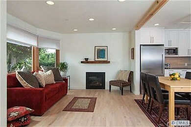 View of living room and part of dining, fireplace 