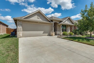 Ranch-style house featuring a garage, a front lawn