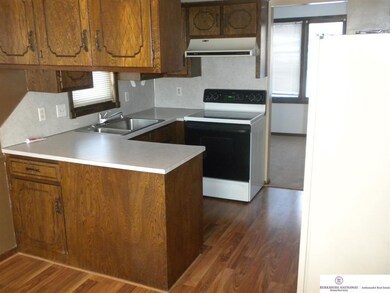 Kitchen with pergo floors and a nice sized dining area.  Walk out to a newer deck off back of the house.