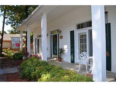 Exterior Front. Large porch with 2 sets of French