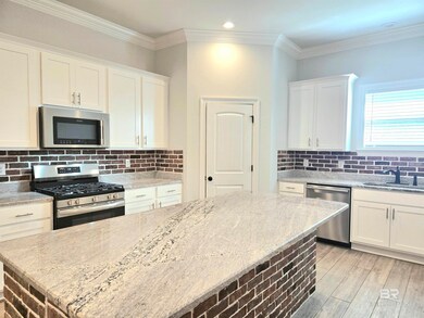 Kitchen featuring backsplash, white cabinets, stainless steel appliances, crown molding, and recessed lighting