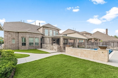 This spacious backyard features a beautiful brick