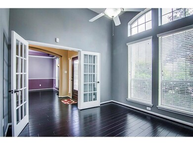 Bright study room with dark hardwood floors, large