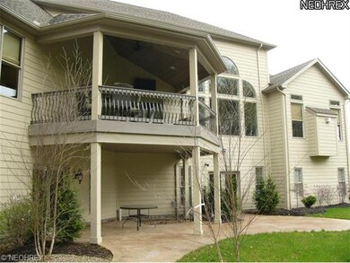 Rear view showing 2 story covered porch.  Upper le