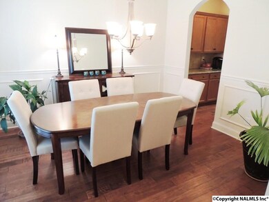 Separate Formal Dining Room welcomes your guests into your HOME-Arched Doorways-Wood Floors-crown molding & trim details accent this pretty space