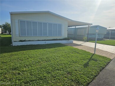 View of property exterior featuring a lawn and an