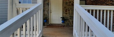Freshly painted front porch with stone accents fra