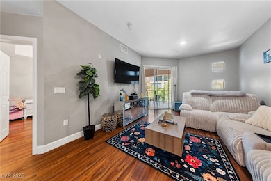 Living room featuring wood finished floors, visibl